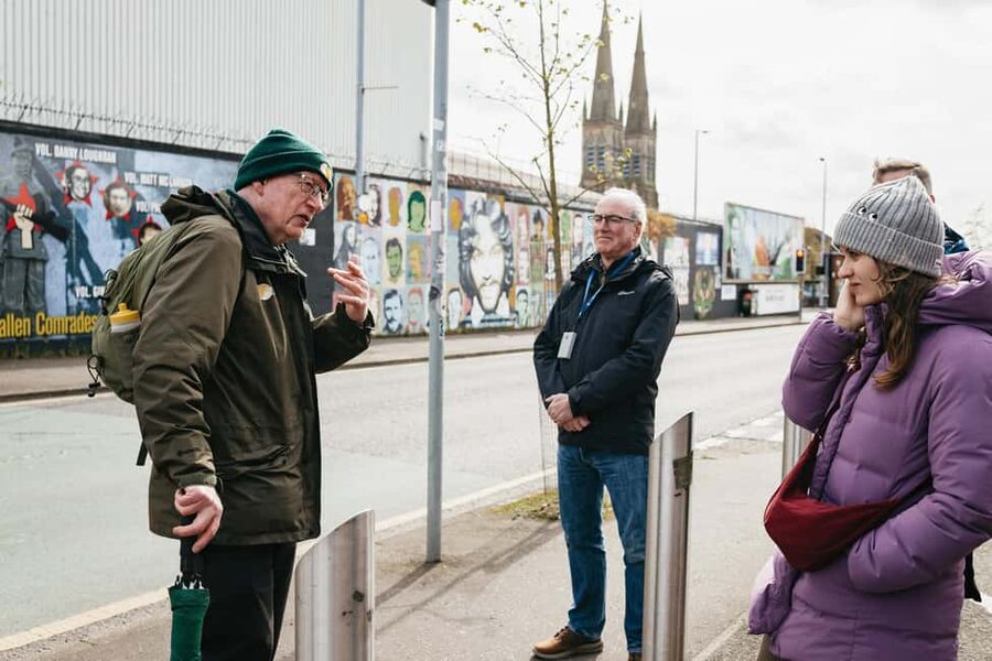 Belfast: The Troubles Walls & Bridges Guided Walking Tour - Back toward the Falls Road: Irish ballads and locked-in atmosphere