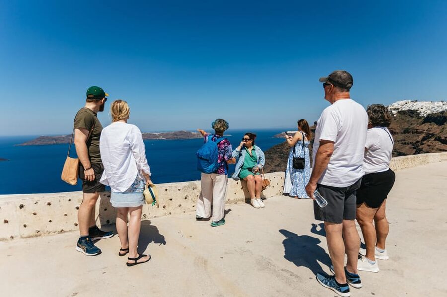 Fira: Guided Foodie Walking Tour with Tastings - The daily market stop and a midday meal with caldera views