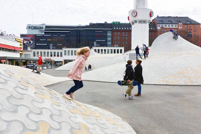 Helsinki walking tour with a city planner - The Runeberg statue and Swedish Theater: language shows up in the streets