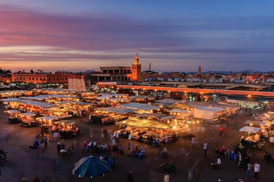 Marrakech: Souk by Night Medina Guided Walking Tour. - Entering the night Medina: meeting at Café de France