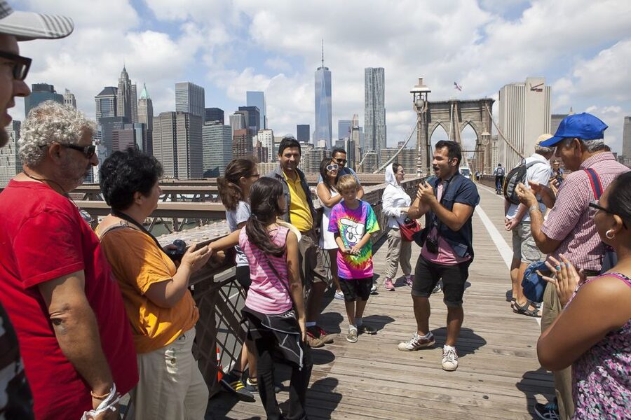 NYC: Brooklyn Bridge and Dumbo District Walking Tour - Crossing the Brooklyn Bridge: views first, then the story behind the steel