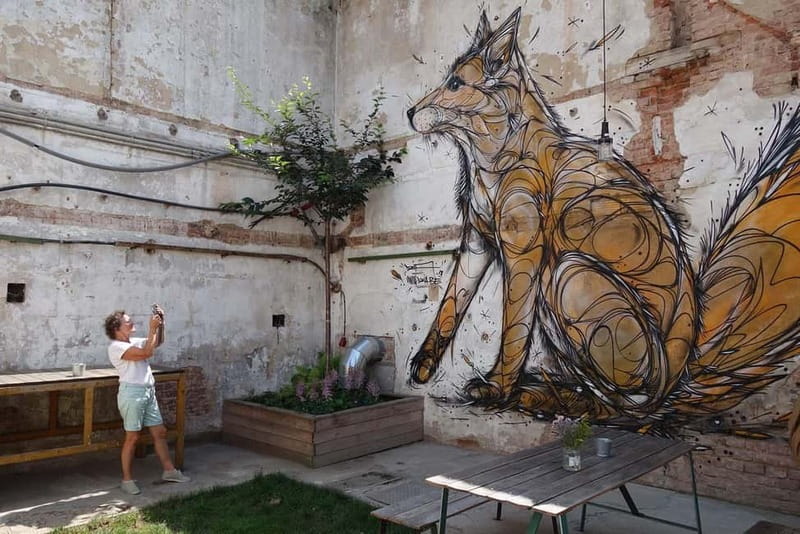 Prague: Alternative Prague Walking Tour - The Underground Finale: Techno and Art in a Venue Made from Old Bus Parts