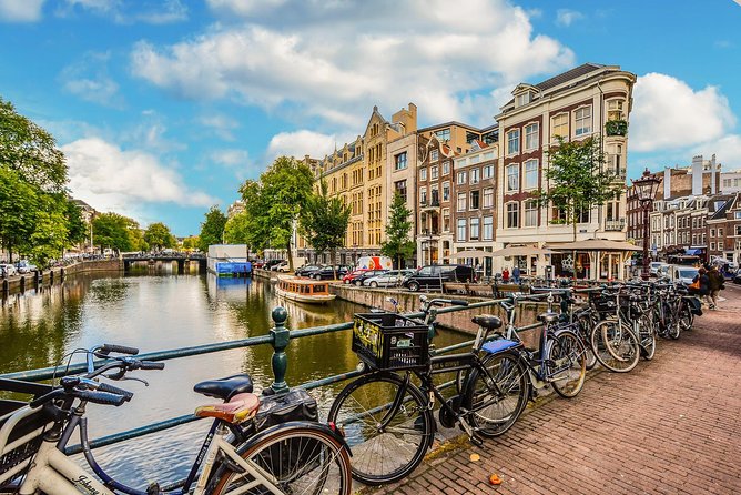 Private Tour: Amsterdam City Walking Tour and Canal Cruise - From tram to Dam Square: Royal Palace and the Monument to war victims